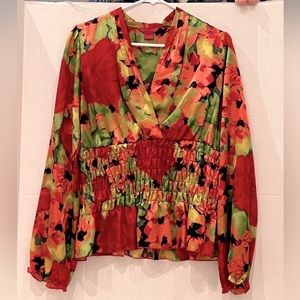 Women’s multicolored Sunny Leigh blouse. Smocking at waist for a flattering fit.